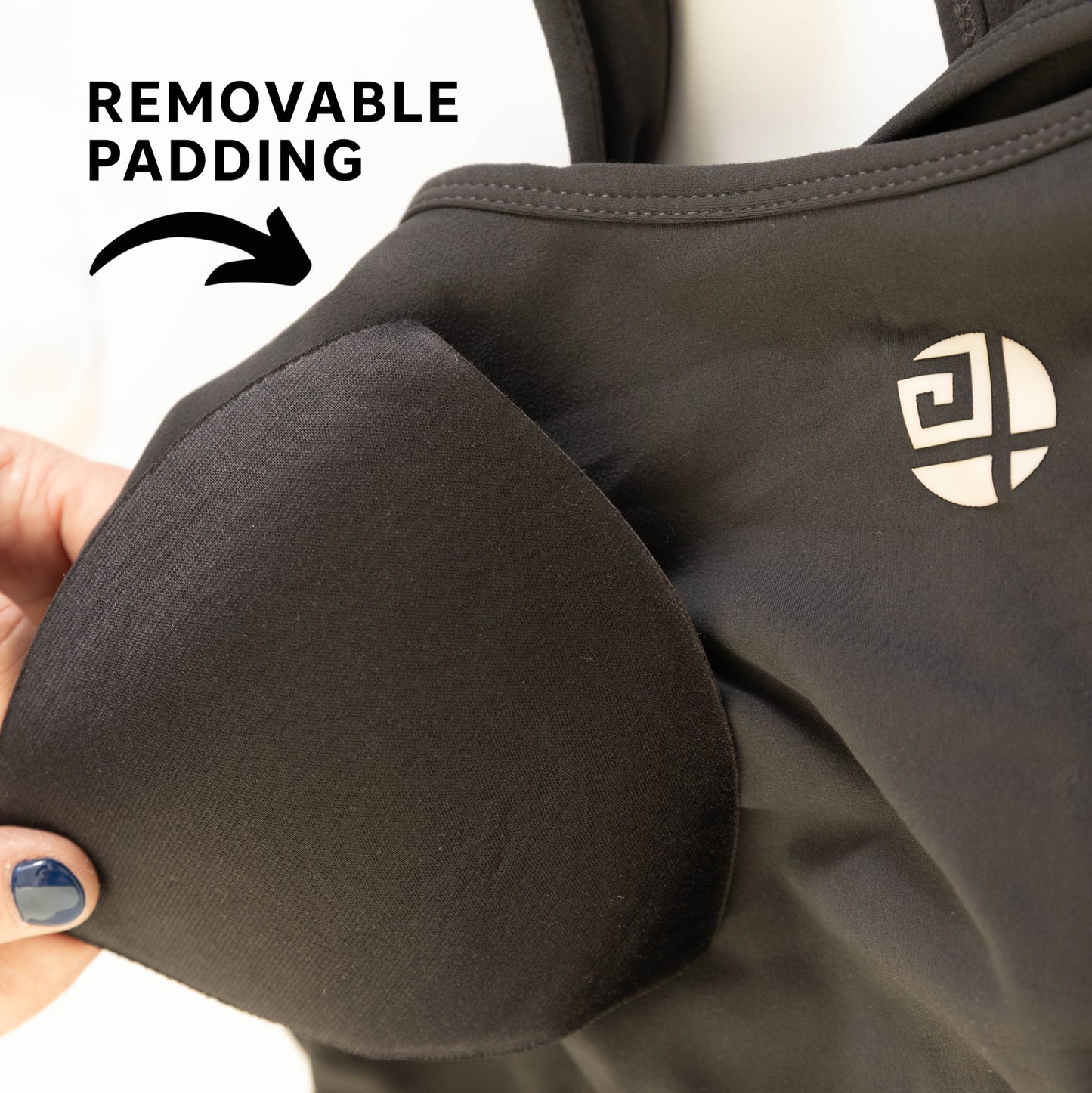 Close-up of Gym Stuff Plus grey sports bra showing removable padding and soft supportive fabric for plus size women.