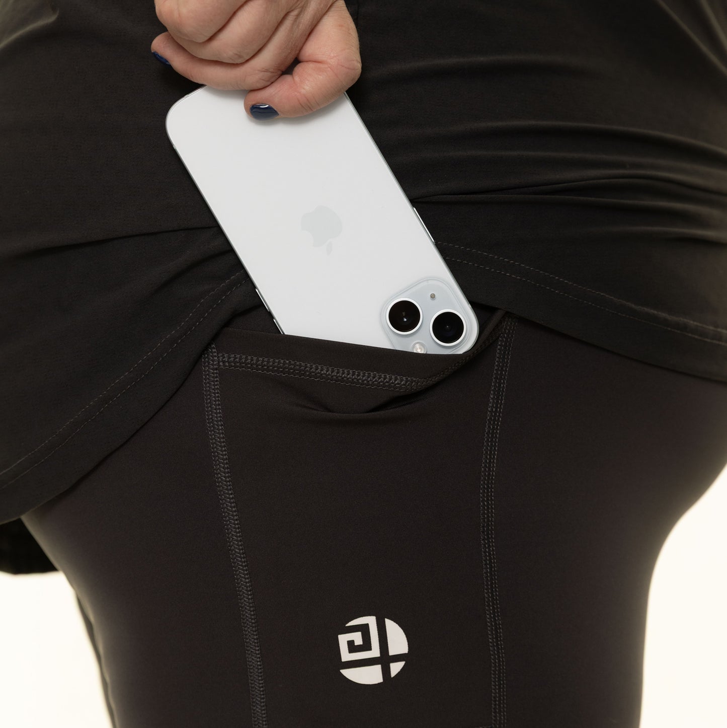 Close-up of Gym Stuff Plus black high waist leggings showing side pocket holding smartphone, supportive flattering fit for plus size women.