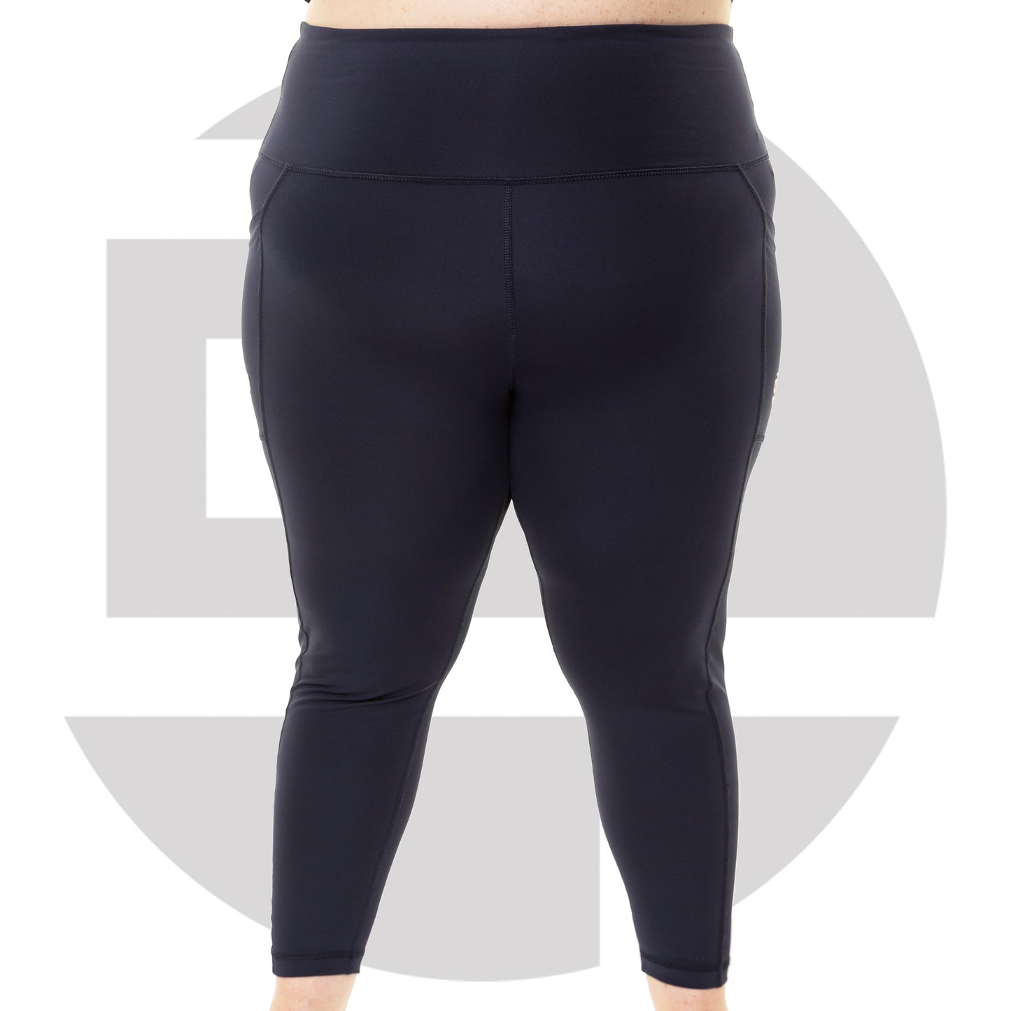 Plus size woman wearing navy high waist squat proof leggings from Gym Stuff Plus, supportive fit with pockets.