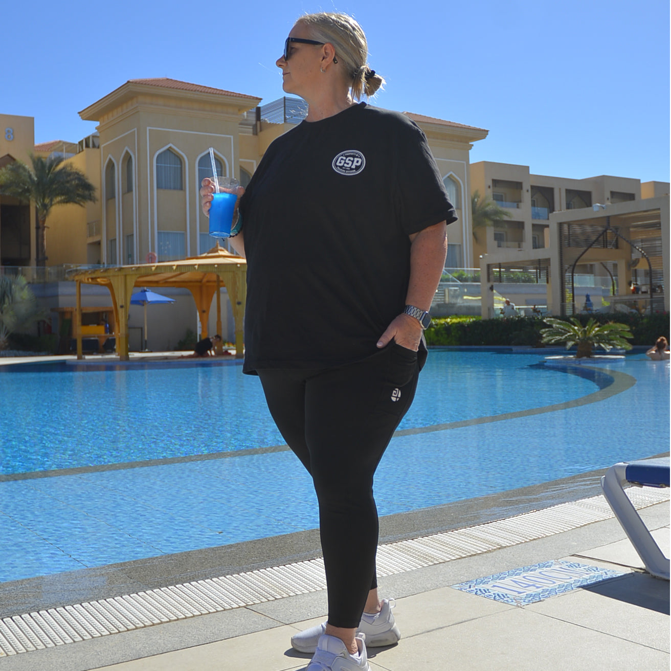plus size black  off duty t-shirt women walking by pool