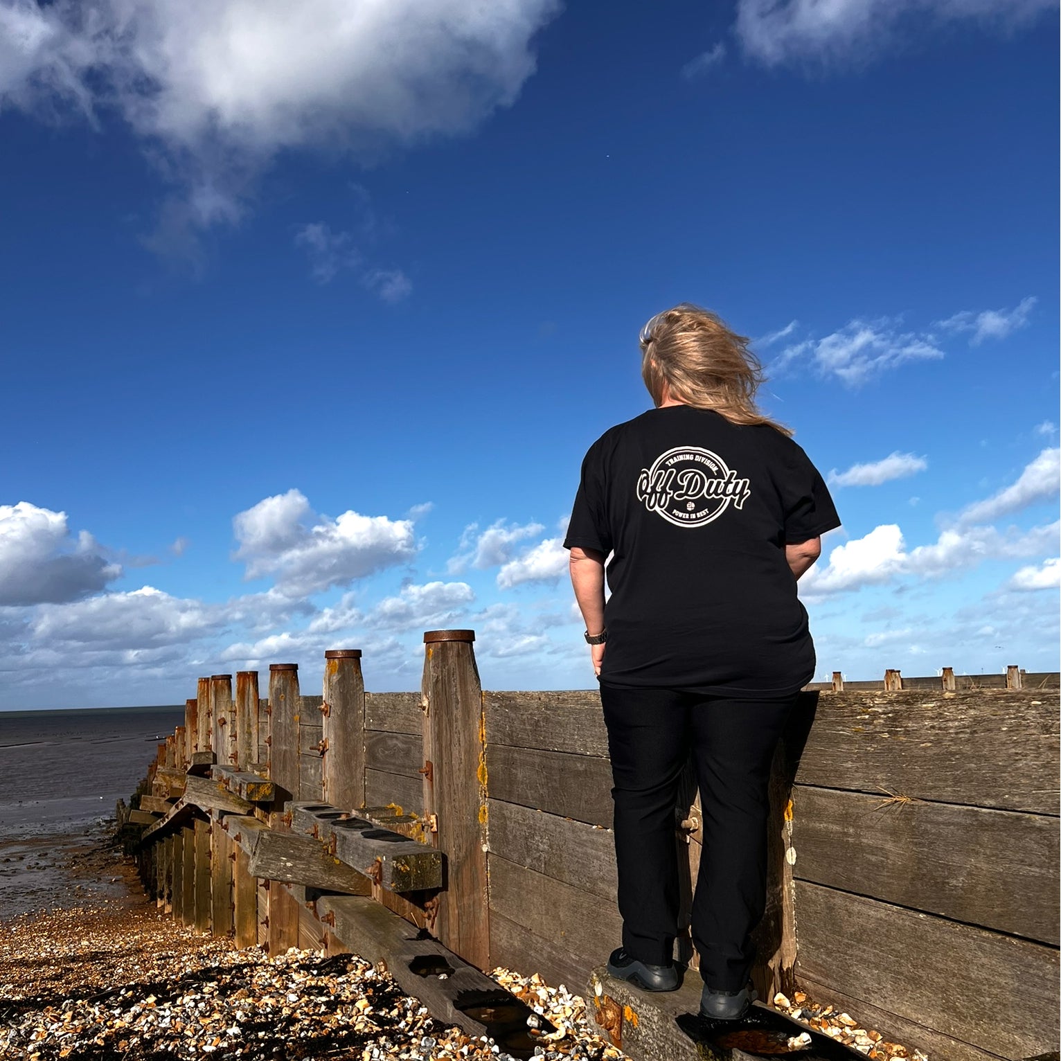 plus size black off duty t-shirt women walking beach back graphic