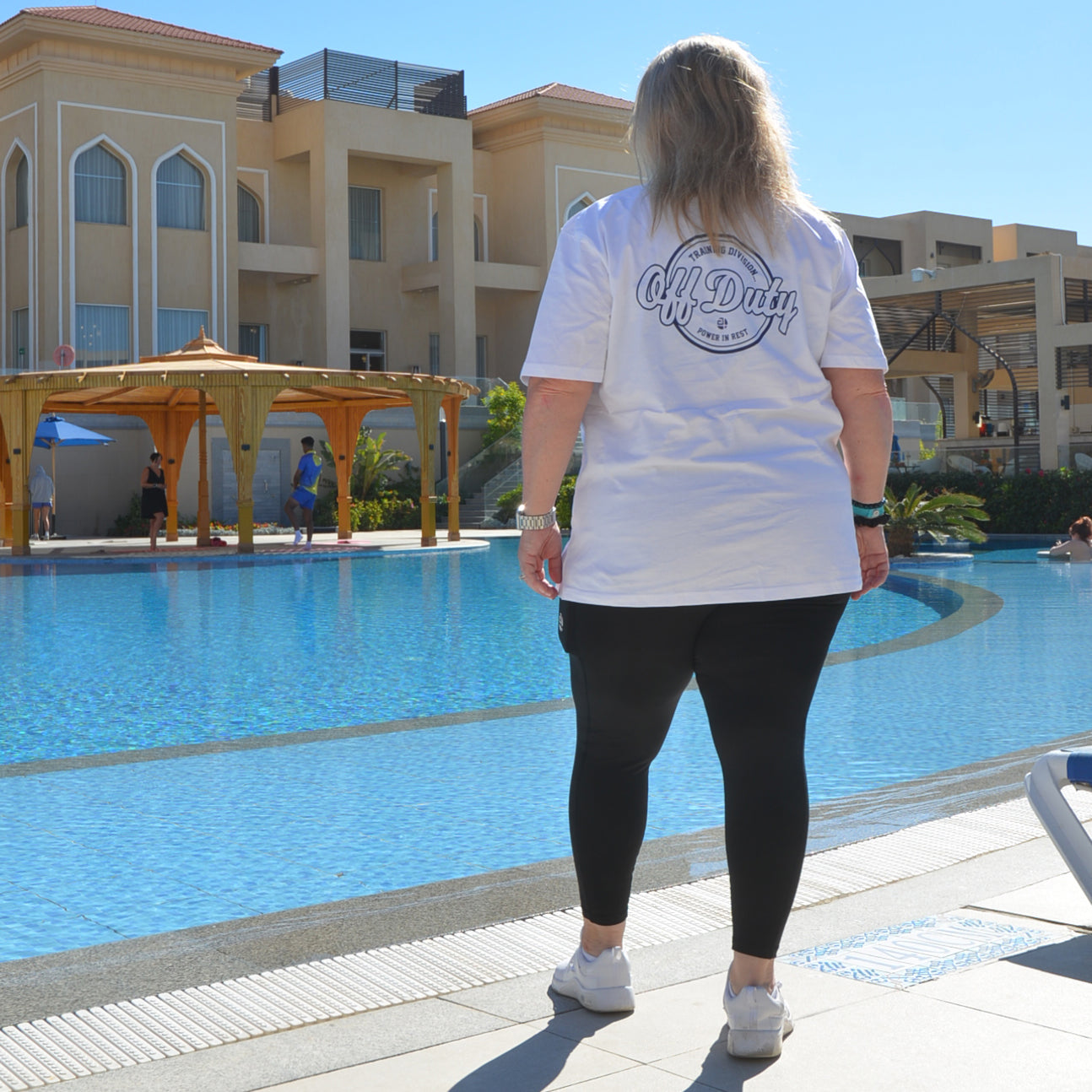 plus size white off duty t-shirt women walking by pool back graphic