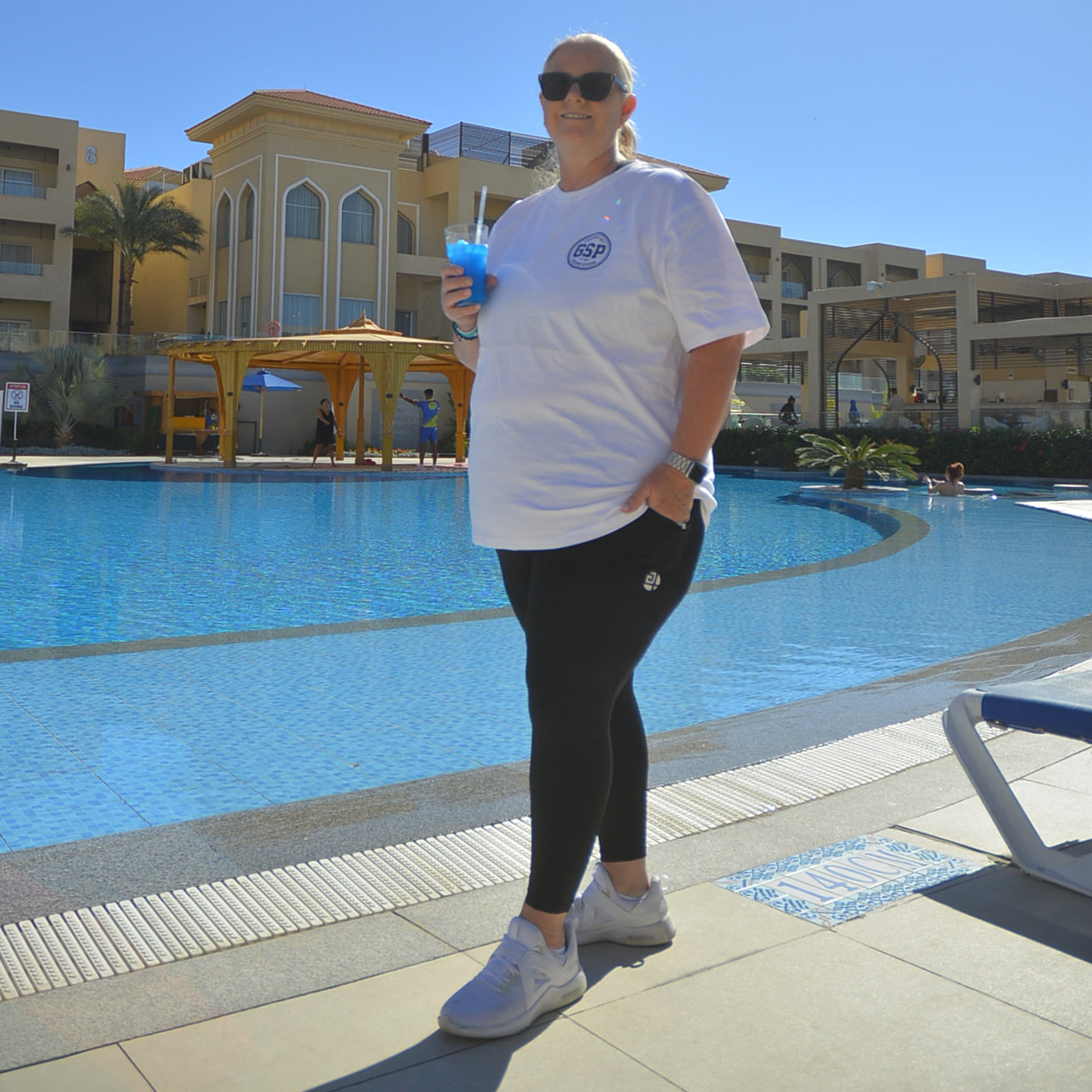 plus size white off duty t-shirt women walking by pool gym stuff plus